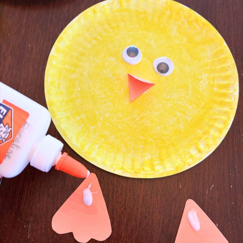 gluing on the chick's feet