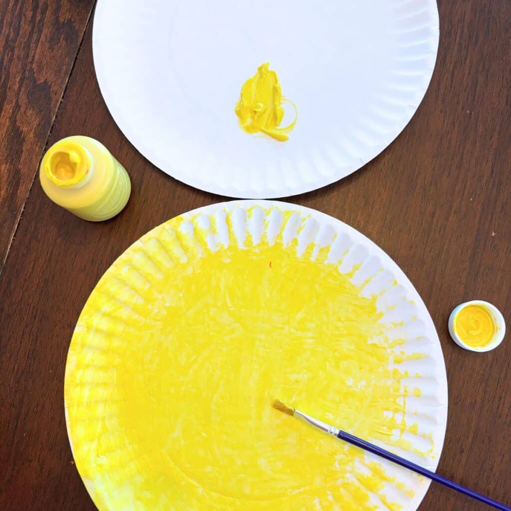 painting the paper plate yellow