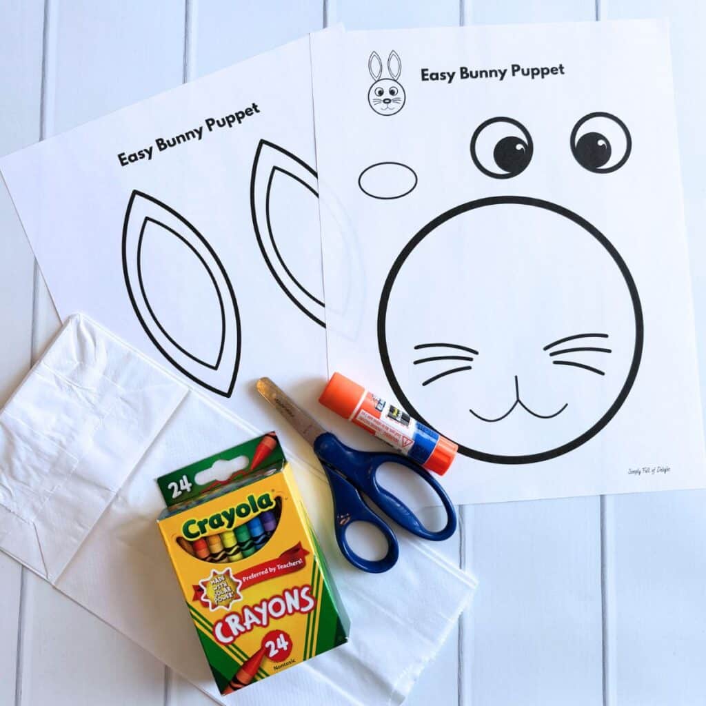 bunny puppet supplies including free template, scissors, paper bag, glue stick and crayons