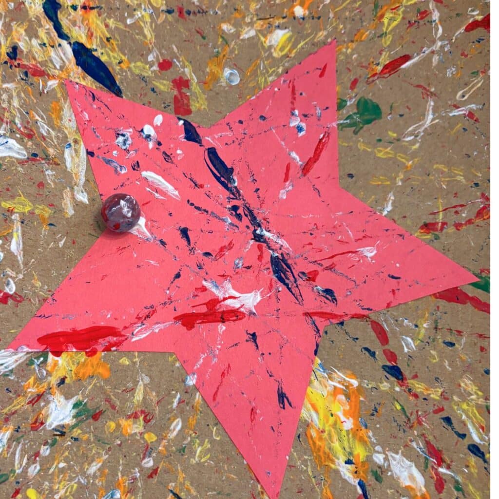 marble painting a red star for 4th of July