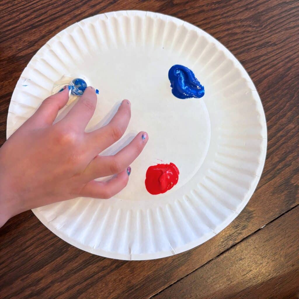 dipping the marble into the paint