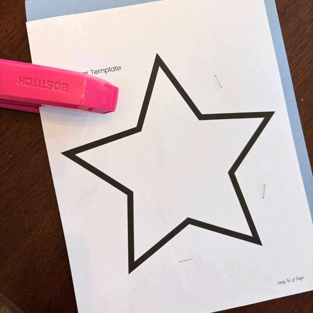 star template stapled to stack of construction paper