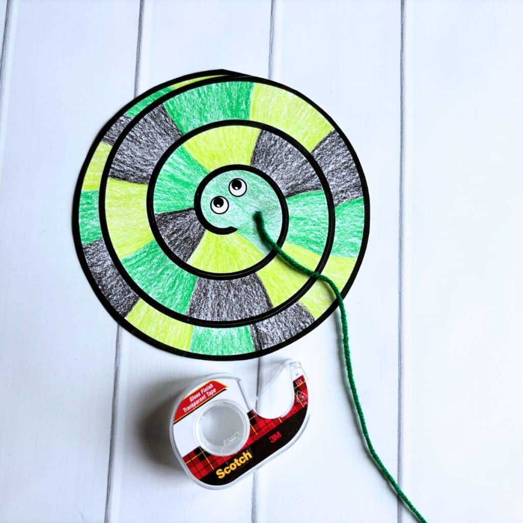 snake printable craft with yarn taped to top.