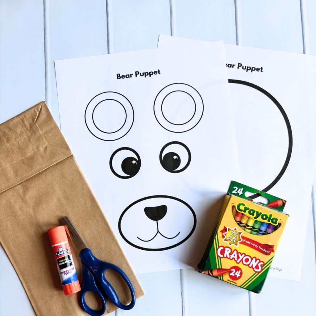 supplies for bear paper bag puppet: free bear template, crayons, glue stick, scissors, paper bag