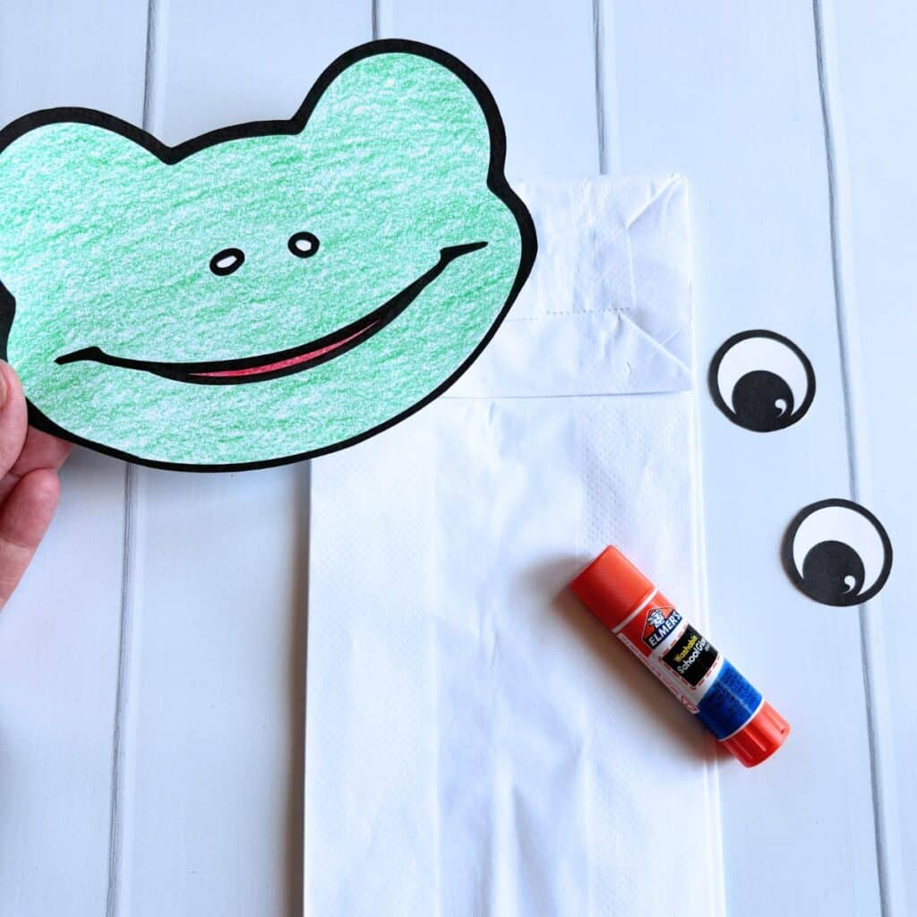 assembled frog template on paper bag.
